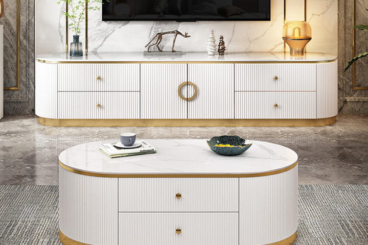 The Isotta media console — a lacquered cabinet with brass inlay and a matching oval centre table