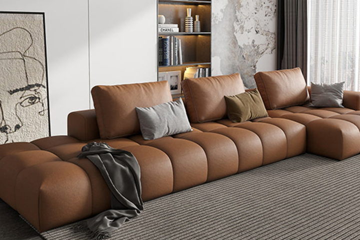 The Stella sofa — a channel-tufted modular sofa in tan leather