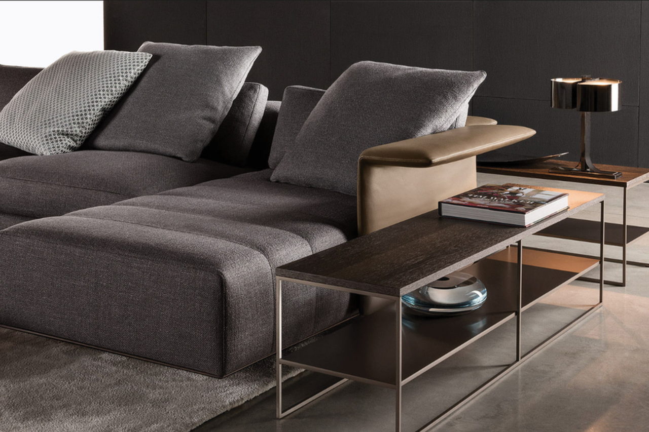 Close detail of the Alessia sofa, showing the tailored seam line and the bronze side table