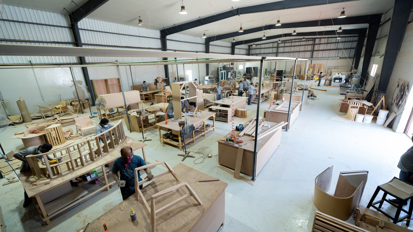 The FlorenStyle production facility, with furniture frames in progress across the workshop floor